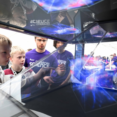 Children looking at a hologram of the universe
