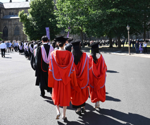 Student procession heading toward the Cathedral, PhD students at the back