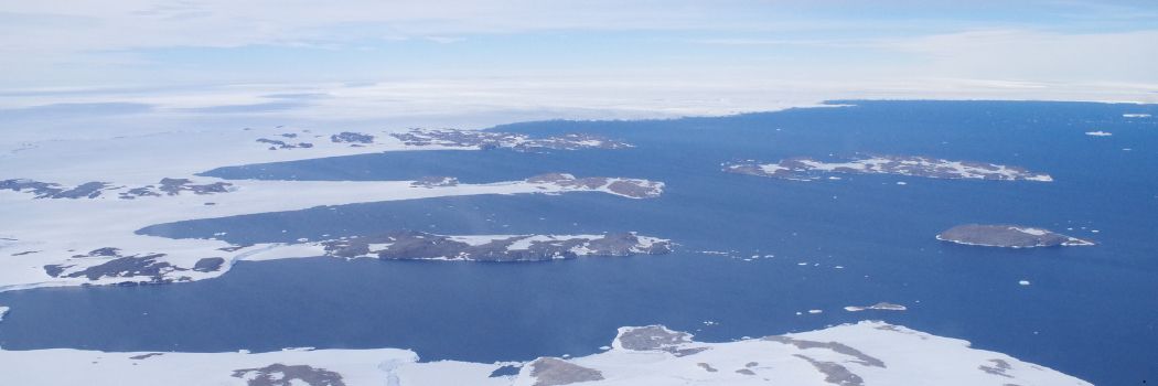 A snow and ice landscape next to the sea