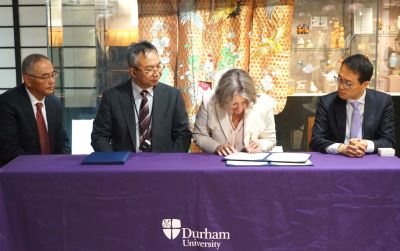 VC Prof Karen O'Brien signing the MOU with the National Museum of Japanese History, with delegates from the NMJH and the Culture Minister, sitting a t a table in the Oriental Museum
