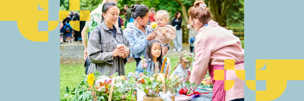 Parents and young children outdoors at a flower stall