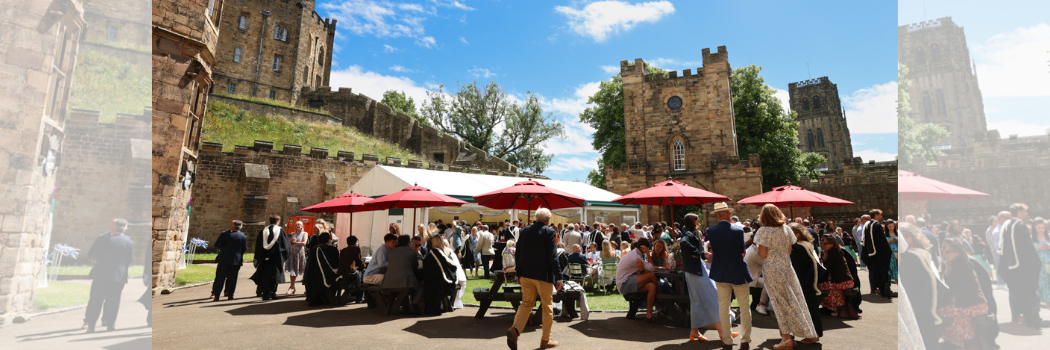 The courtyard of Castle College in the sunshine with people sitting around wooden tables