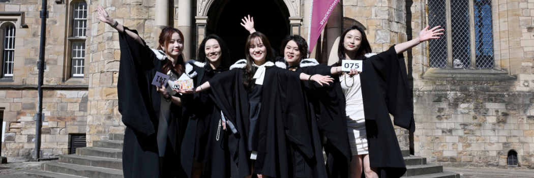 Group of 5 students in front of University College steps