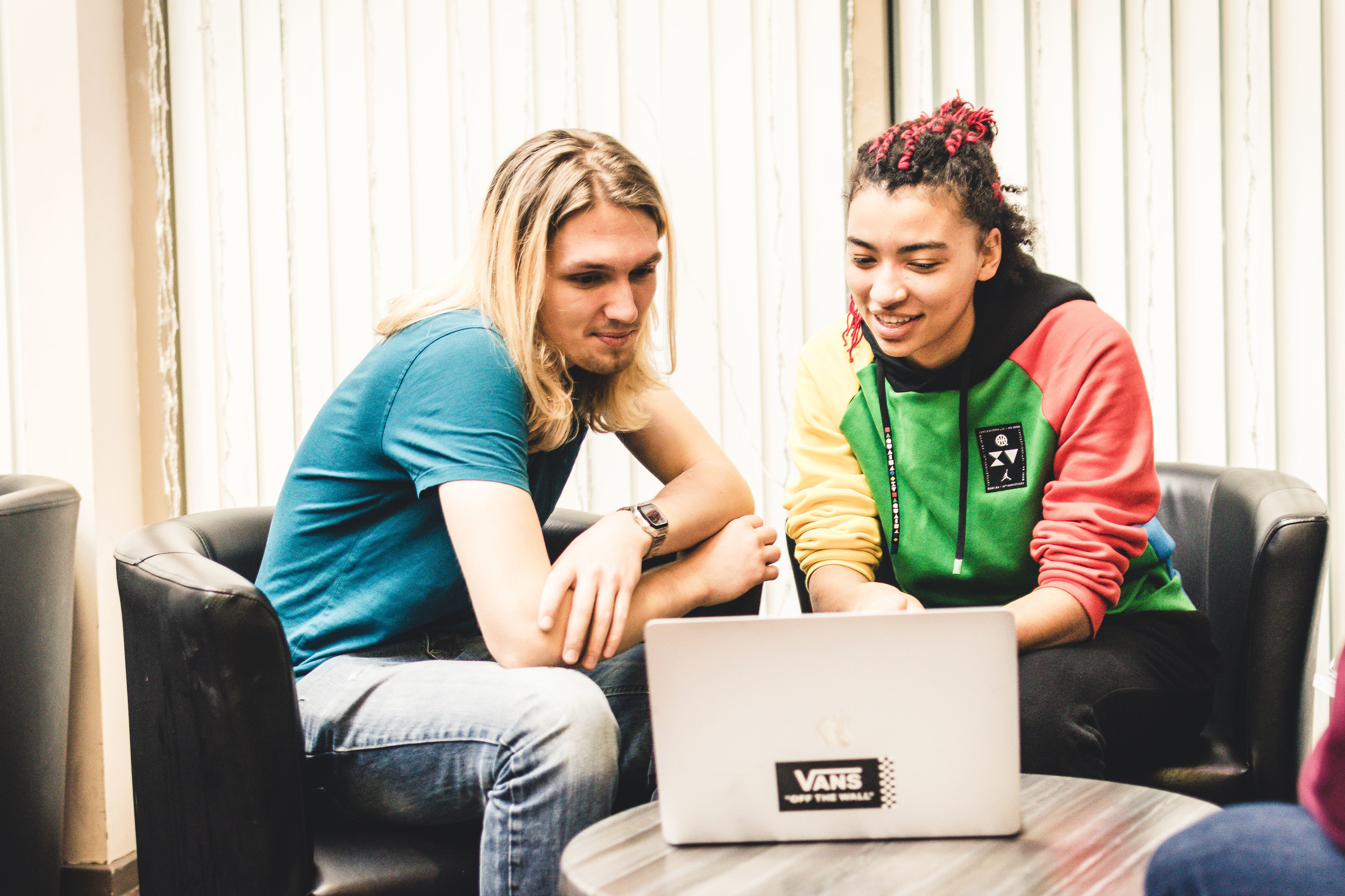 Two students looking at a laptop