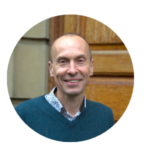 a man smiles in front of a door
