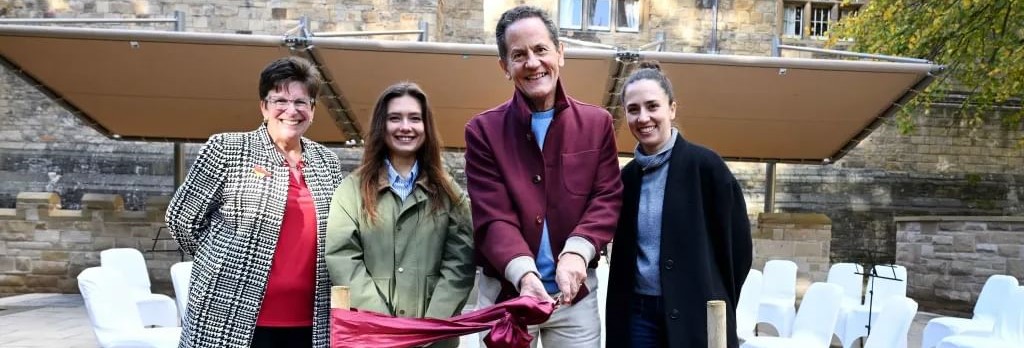 Alumni donor, James Riley cutting a ribbon to officially open Fellow's Garden