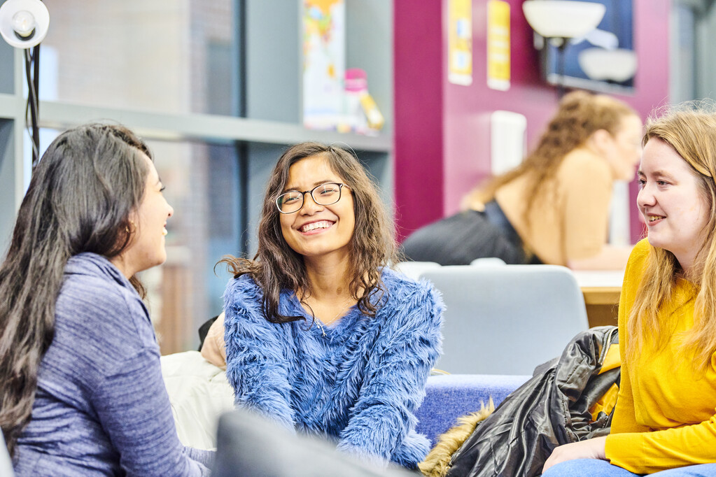 photo of students sitting in the cafe chatting.