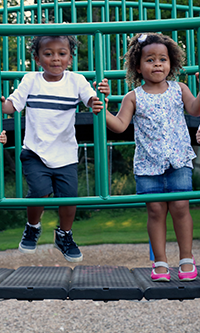 Two children playing on a climbing frame
