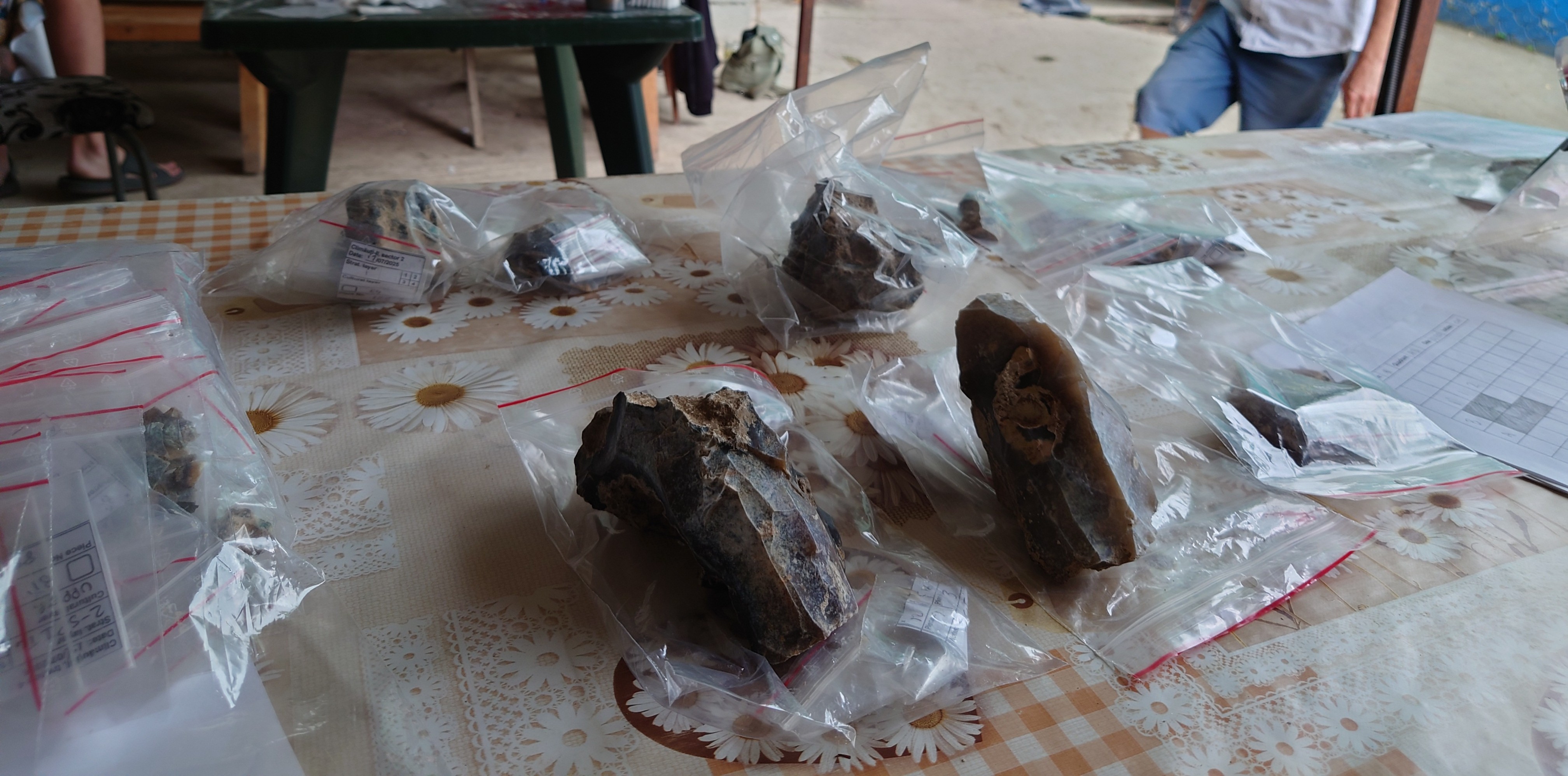 Close-up photo of two blade cores from flint knapping amongst other finds in clear plastic zip up bags.