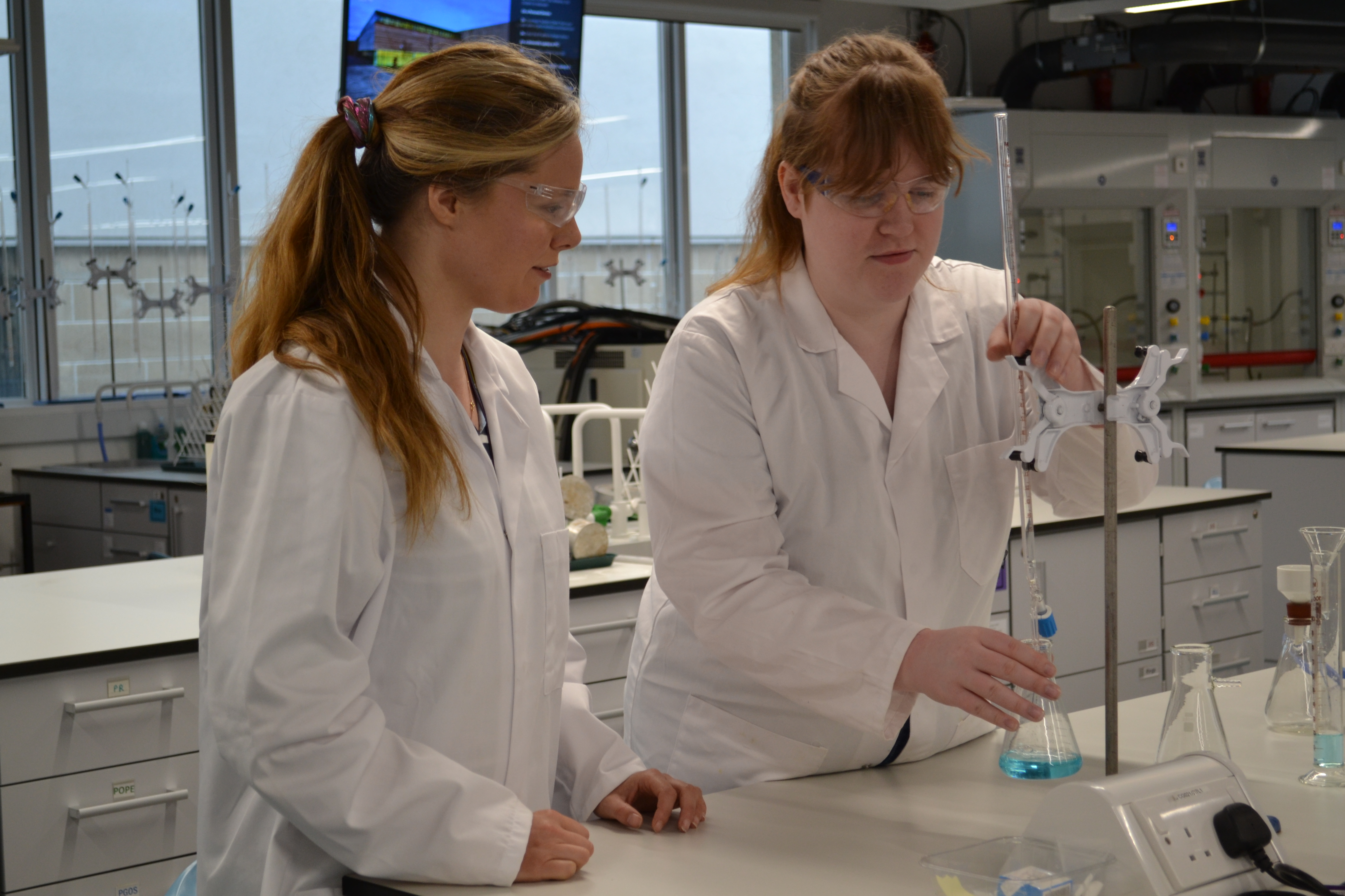 Two researchers performing an experiment in our chemistry lab