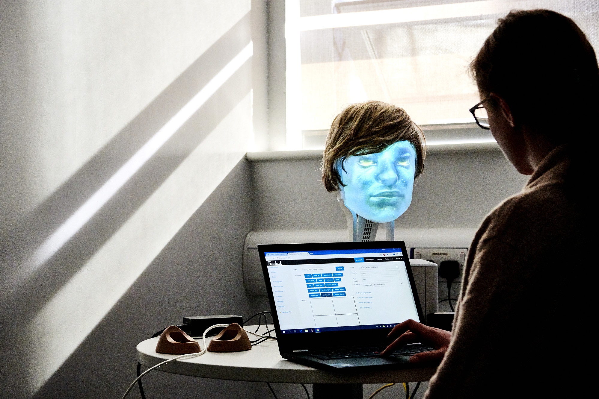 Someone studying a robotic face