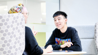 TA male and female student facing eachother.