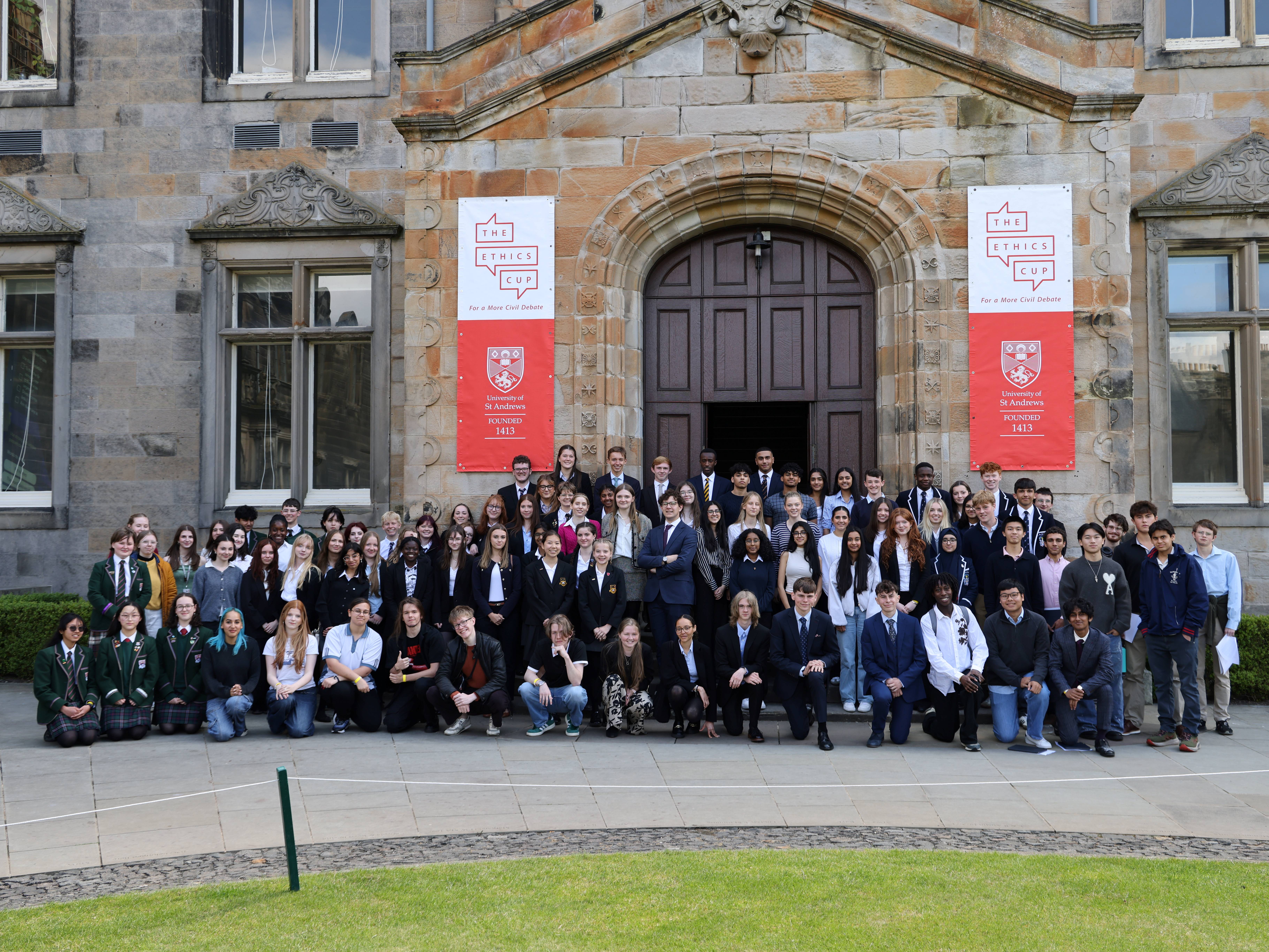 A group photo of pupils outside a university building