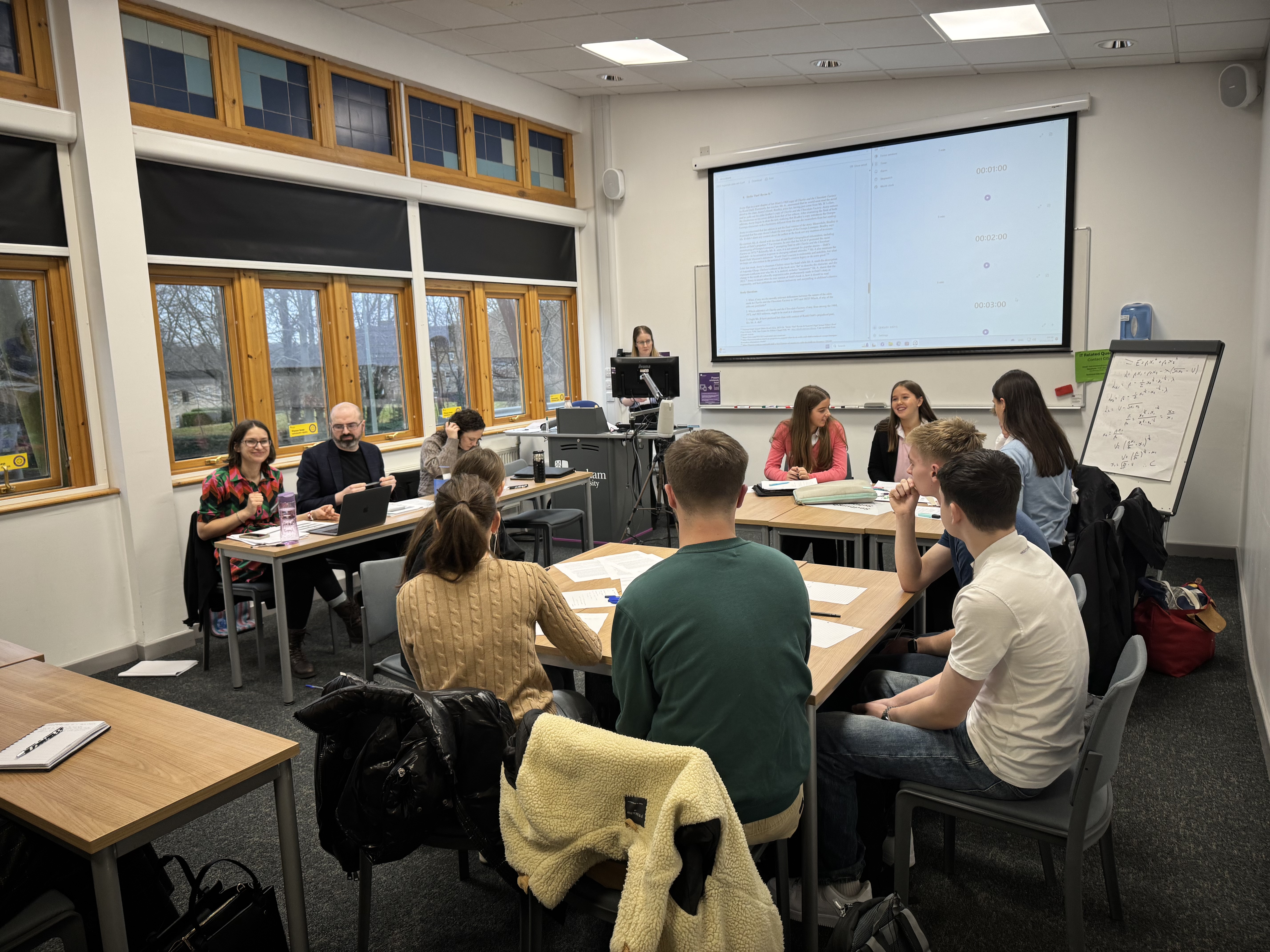 A group of students sat in a circle discussing.