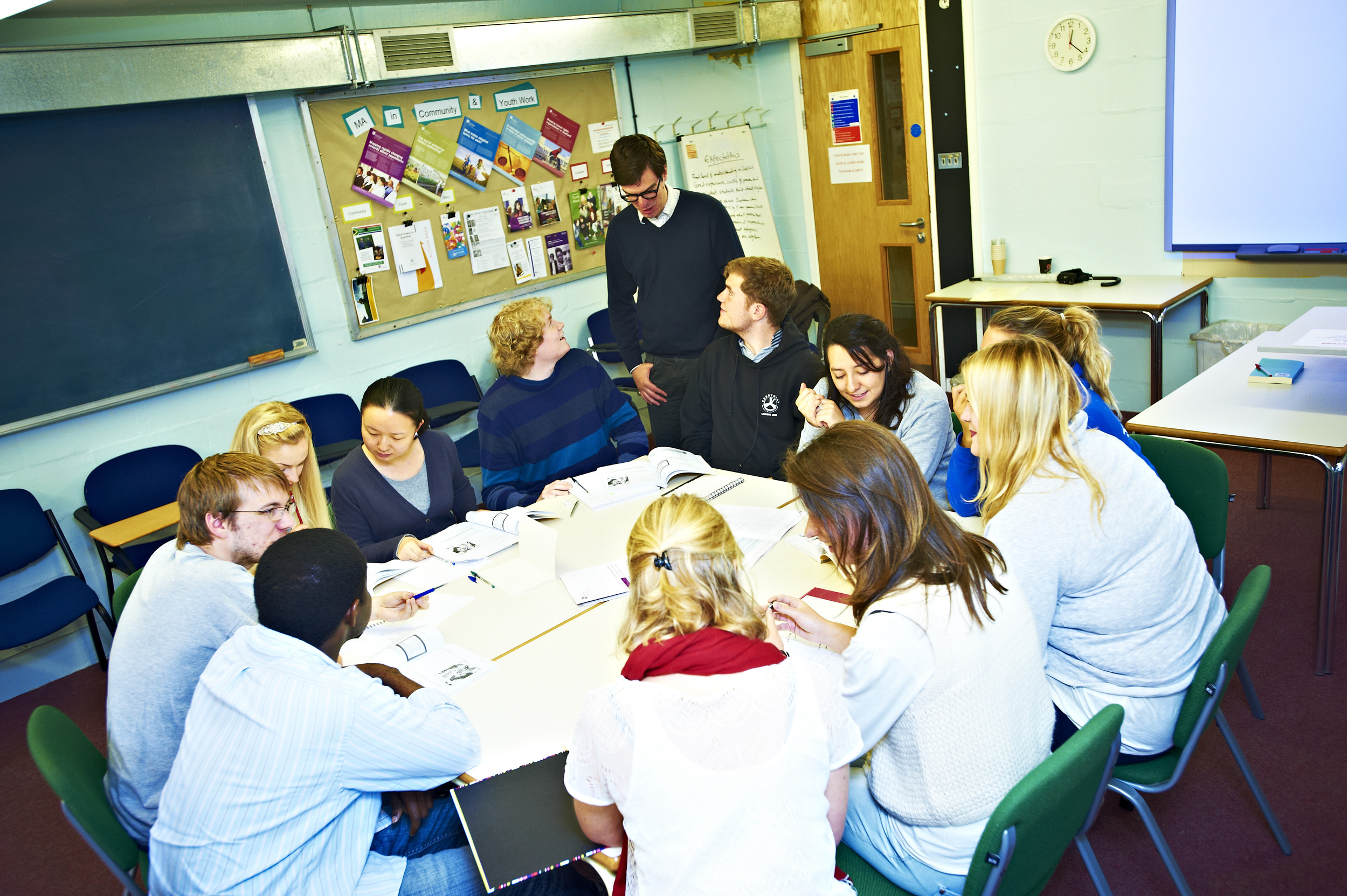 Students having a discussion round a table
