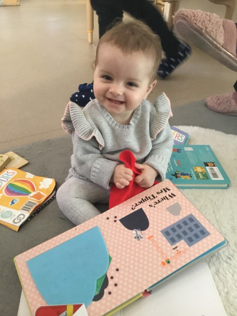 child sitting smiling snowdrops