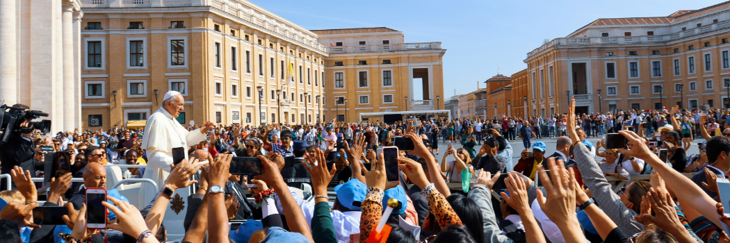 Pope Francis greeting crowds of people