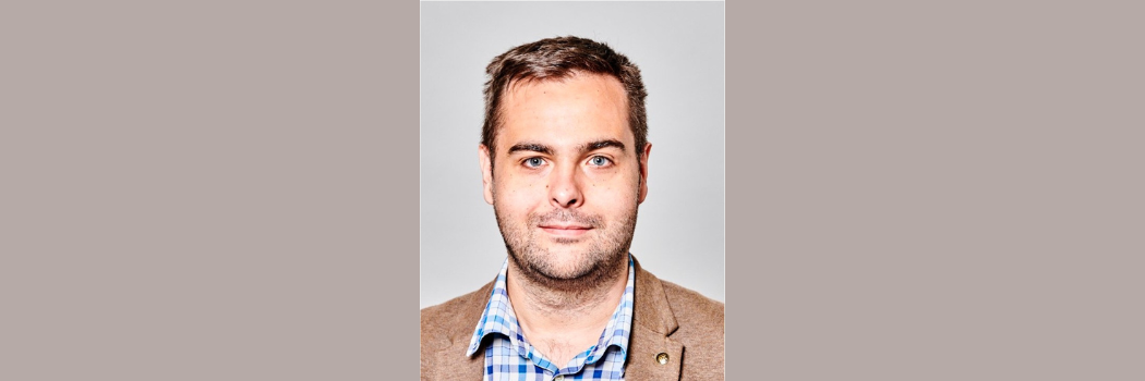 Associate Professor Dr Will Brittain, pictured against and plain background