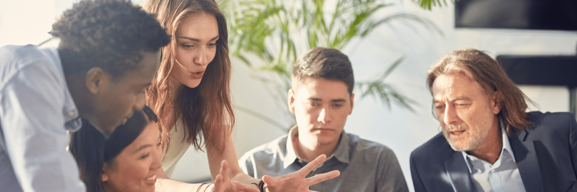 A group of business people looking at a laptop