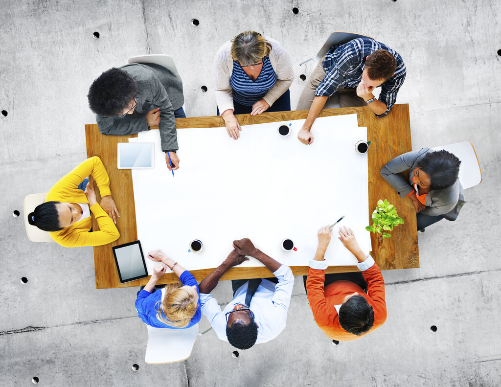 Researchers in discussion around table