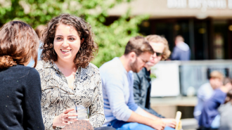 A female student chatting to others outside