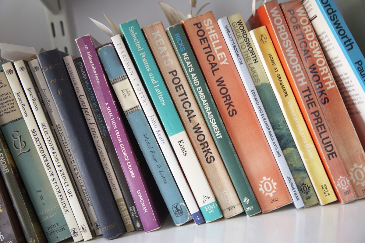 A row of poetry books on a shelf