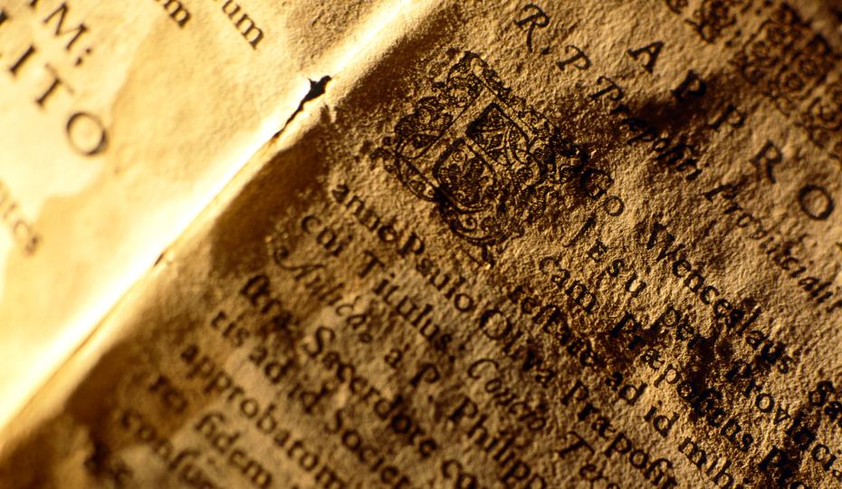 An open Religious Codex on ancient handmade paper, the text is written in Latin