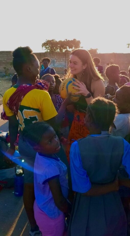 Student with Zambian children