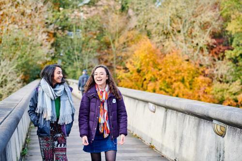 Two students crossing Kingsgate Bridge